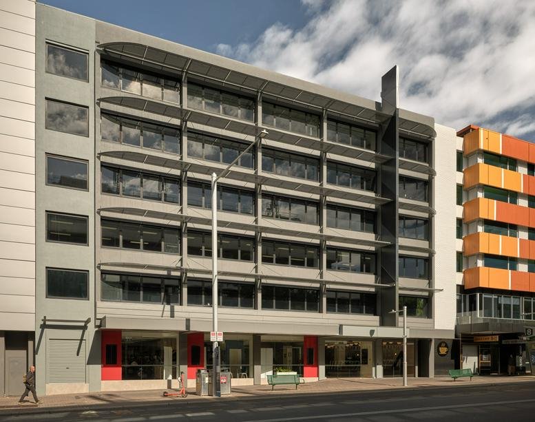 Exterior view of the multi-story grey and glass building at 4, Mort Street, Level 3.