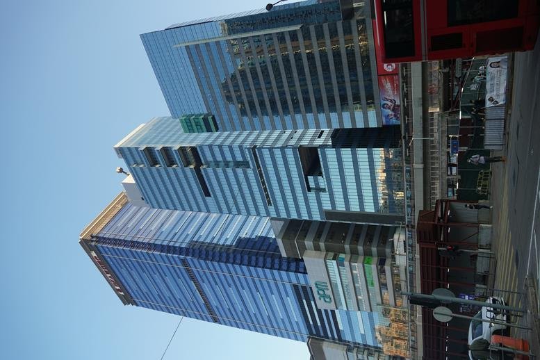 Exterior view of the modern glass towers at One Pacific Centre against a clear sky.