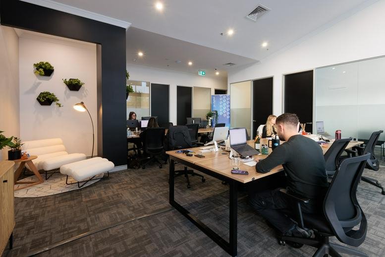 Spacious open-plan workspace at 418-428, Murray Street with plants and modern seating.