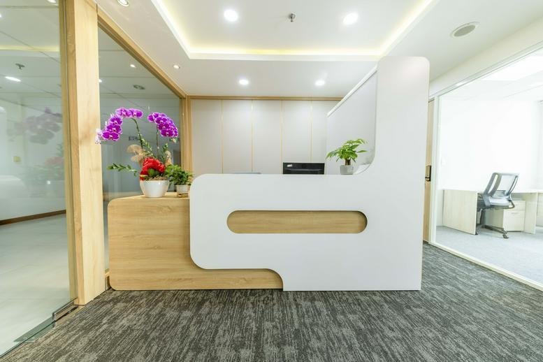 Modern reception desk at 45, Đường Võ Thị Sáu with wood accents and purple orchids.