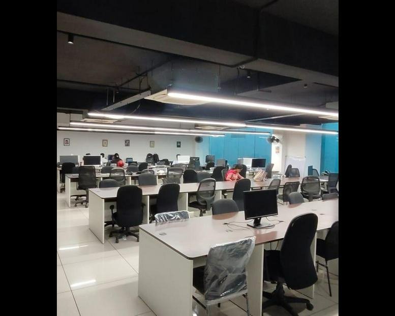 Spacious open-plan workspace at 496 G2, Grand CAG Central with modern overhead lighting and ergonomic chairs.