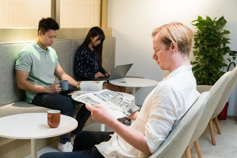 People working and reading in a cozy lounge at 50, Bonham Strand, 2/F, Strand 50.
