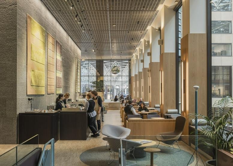 Café-style communal area with large windows and seating