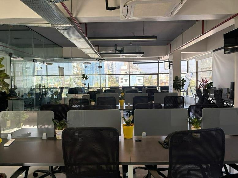 Spacious open-plan workspace at 6 & 7, Sus - Pashan Road with sleek desks and floor-to-ceiling windows.