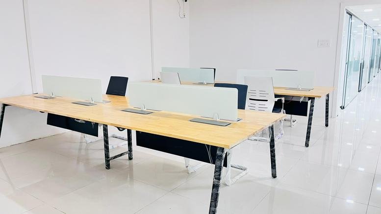 Exterior view of Vasavi MPM Grand building showing modern design with glass windows.