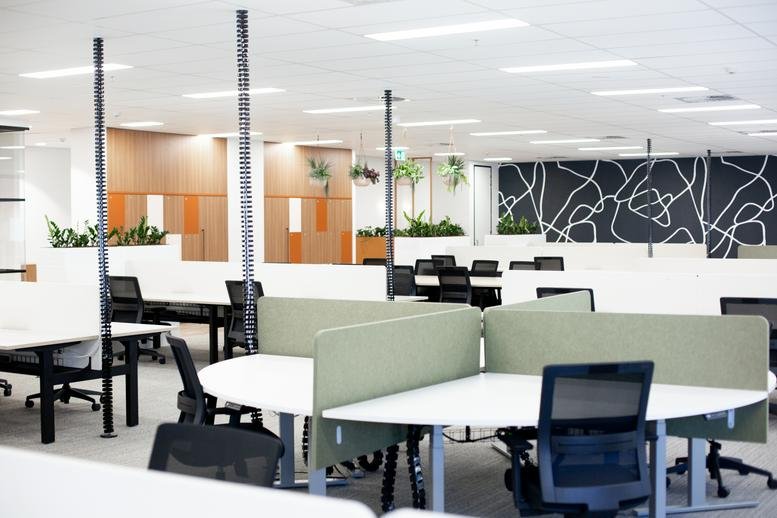 Spacious open-plan workspace at 818, Bourke Street featuring curved desks and modern dividers.