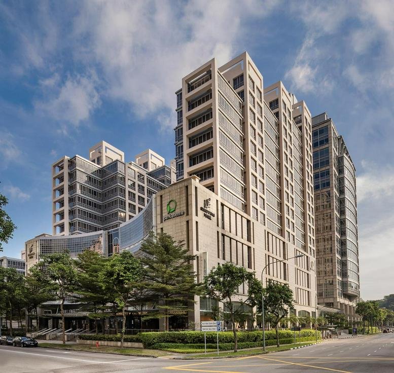 Exterior view of the modern stone and glass facade of the building at 81A Clemenceau Avenue.