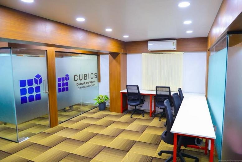 Bright coworking area at 860/A Narendra chambers West of chord road 2nd stage with glass offices and desks.