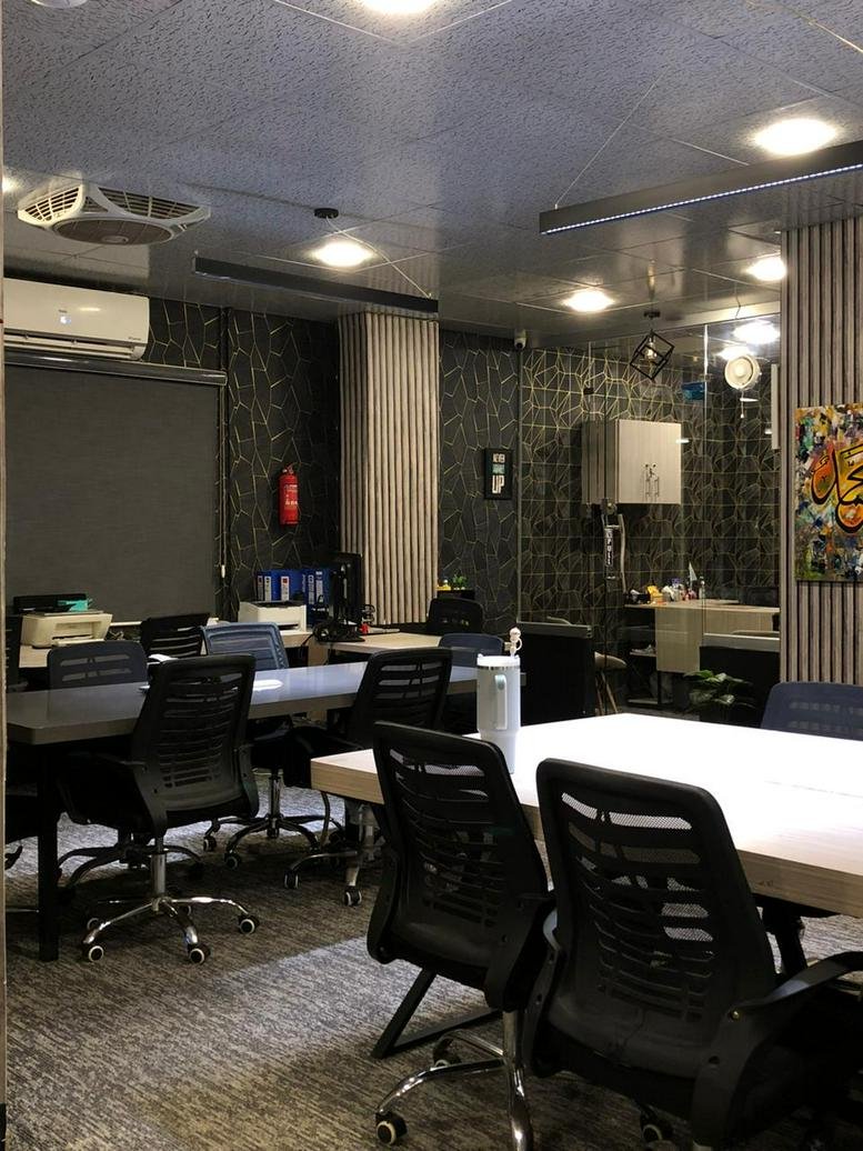 Spacious open-plan workspace at Al Rehman centre, 8, شاہراہ فیصل with multiple workstations and feature walls.