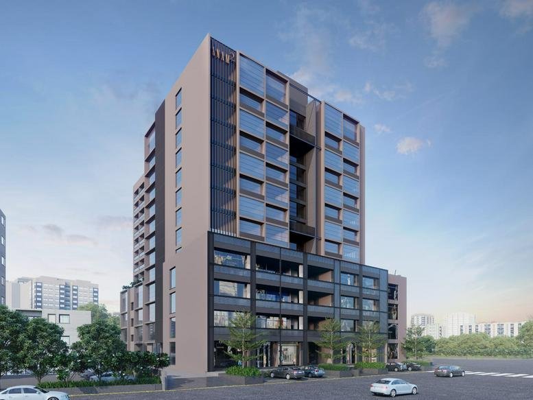 Exterior view of the modern multi-story commercial building Anam 2 with a sleek glass and dark panel facade.
