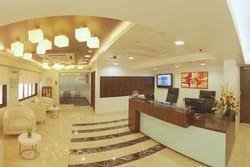 Reception area at British Hotel Lane, Off Nagindas Muster Road , Fort with wood-paneled desk and warm lighting.