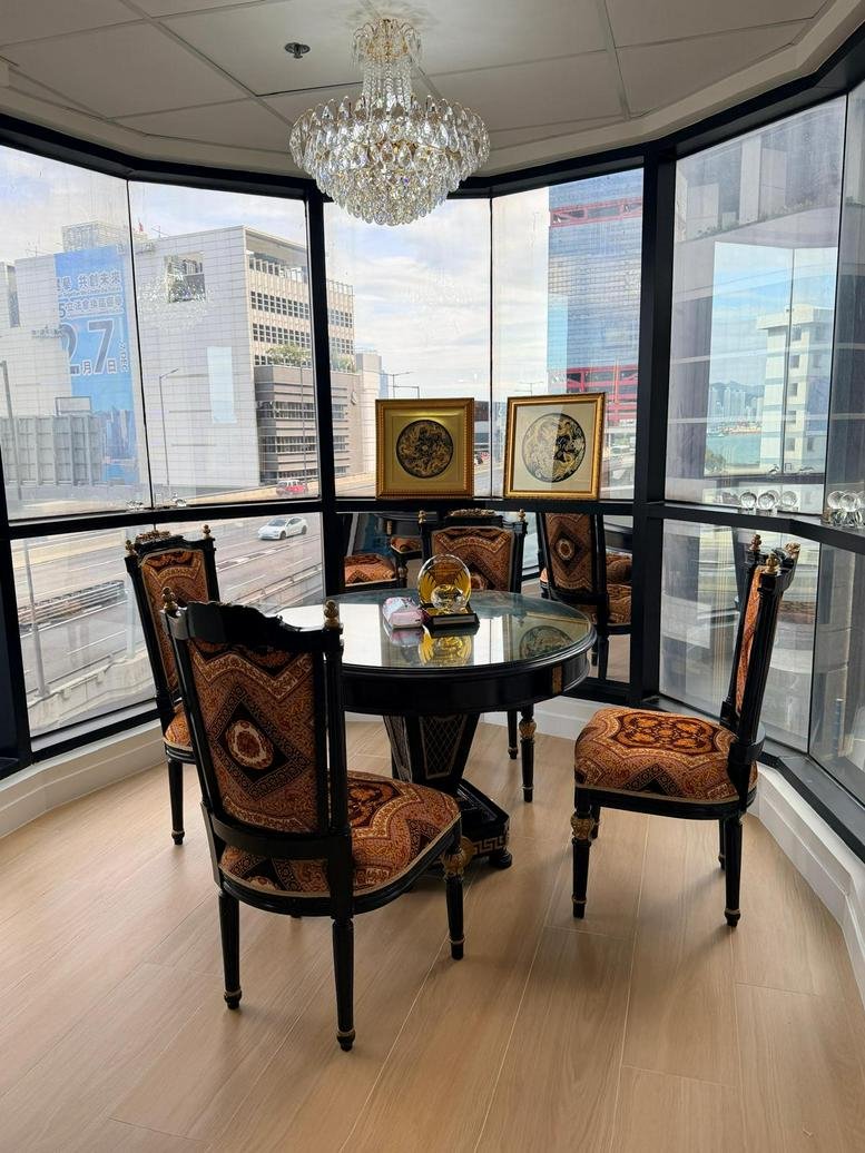 Communal dining area at 1 Des Voeux Road West with ornate furniture and city views.