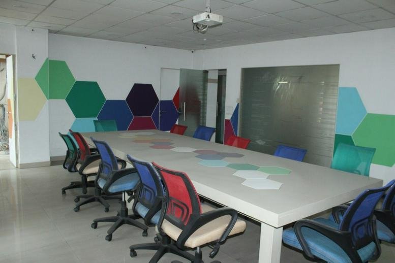 Modern conference area at 12, Shiv Marg, Kirti Nagar, Shyam Nagar, Jaipur featuring hexagonal wall art.
