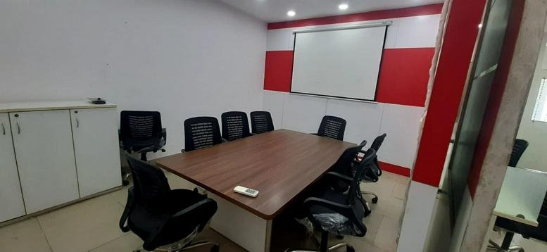 Modern conference room at 12, Shiv Marg, Kirti Nagar, Shyam Nagar, Jaipur with red and white wall accents.