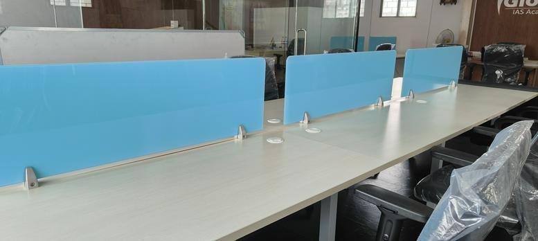 Bright open-plan workspace at 361 sterling arcade featuring white desks with blue privacy screens.
