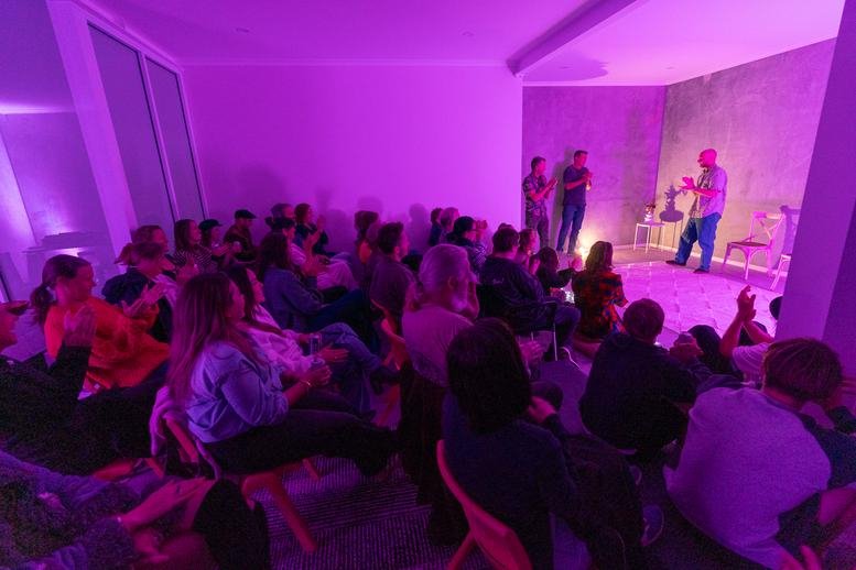 Community event space with tiered seating and purple ambient lighting.