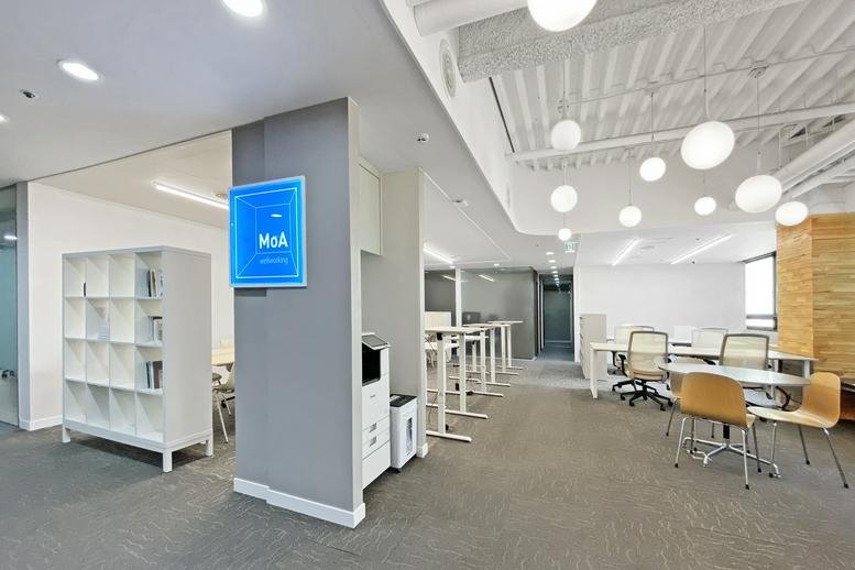 Spacious communal coworking area at 20, 여의대방로65길 featuring modern white shelving and globe pendant lights.