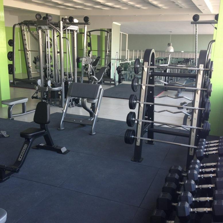 Spacious fitness center at 20 Street 17 featuring weight machines, racks, and a dumbbell area.