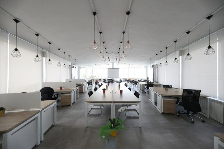 Large open-plan office at 20 Street 17, Baabda, Lebanon with rows of modern desks and hanging lights.