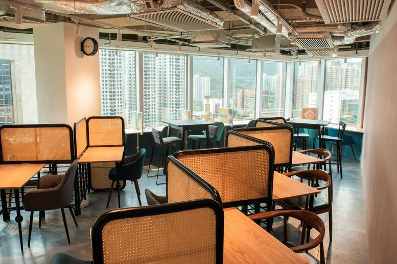 Spacious coworking lounge at Grand Central Plaza Tower 1 with wood desks and city views.