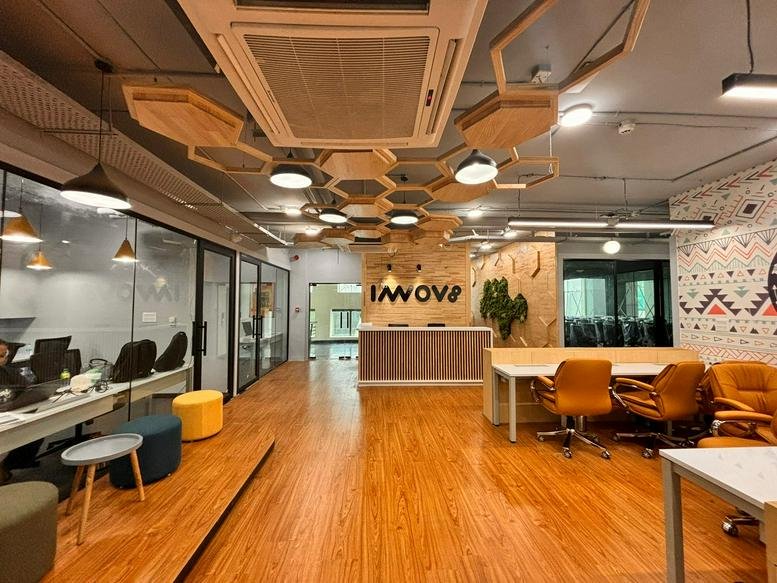 Reception area at 211 Okhla Phase III with wooden honeycomb ceiling and Innov8 branding.
