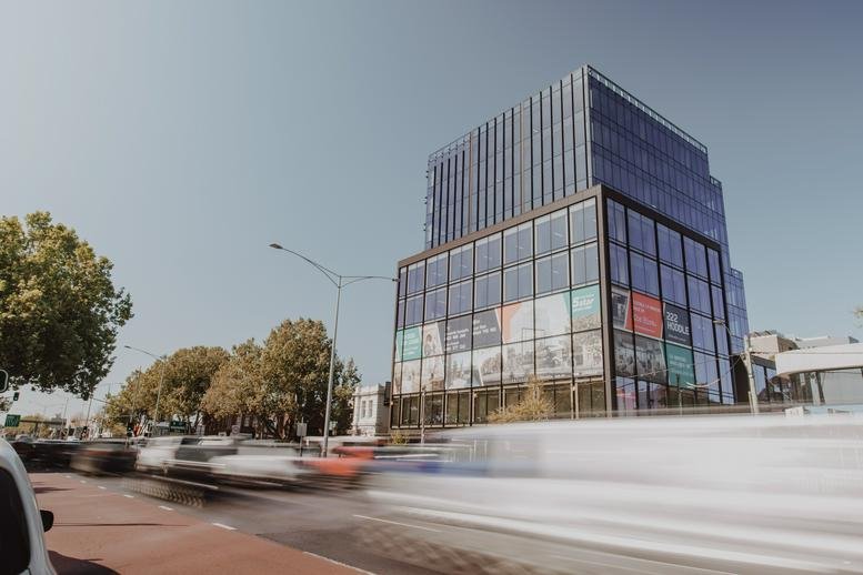 Exterior view of the modern glass and steel building at 222 Hoddle Street, Melbourne.