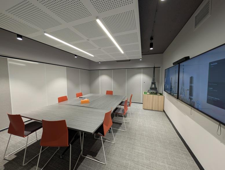 Modern conference room at Level 2, 241 Commonwealth Street with orange chairs and dual screen monitors.