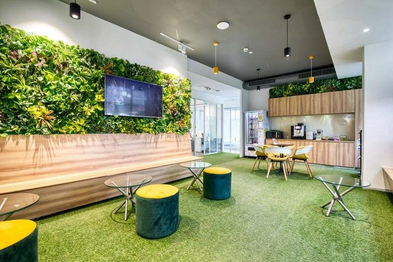 Communal break area at 246, Ashok vihar phase, Gurugram (Gurgaon) with green living wall and turf flooring.