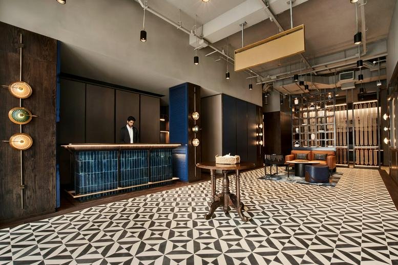 Reception area at 269 South Bridge Road, Singapore featuring a blue tiled desk and geometric patterned floor.