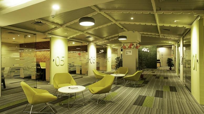 Spacious reception lounge at 34/195, 3rd floor, Oberon mall with lime green armchairs and striped carpet.