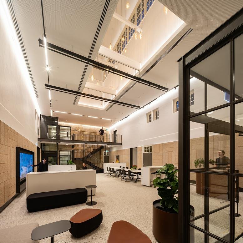 Spacious lobby at Building C104, 5 Fleet Street with high ceilings and integrated architectural lighting.