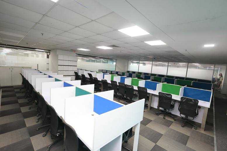Spacious open-plan workspace at RUPA SOLITAIRE, MILLENNIUM BUSINESS PARK with colorful desk dividers.
