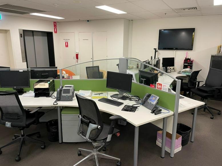 Modern open-plan office at 61 Market Street, Central Business District, Sydney with green-screened workstations.