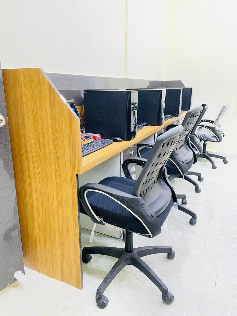 Workspace at 66 Shakespeare Sarani, Beside Uniworth Center, Kolkata with wooden desks and computer towers.