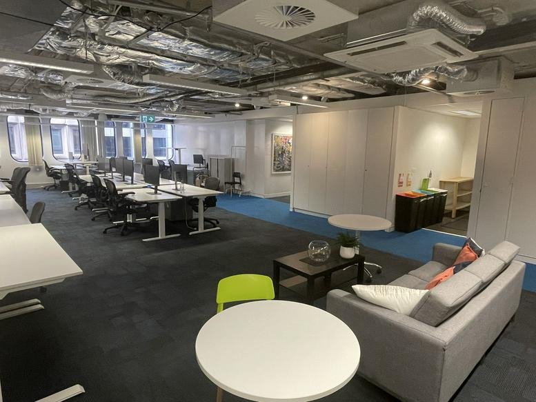 Bright, open-plan office space at 99 York Street, Sydney CBD with rows of white desks and grey carpet.
