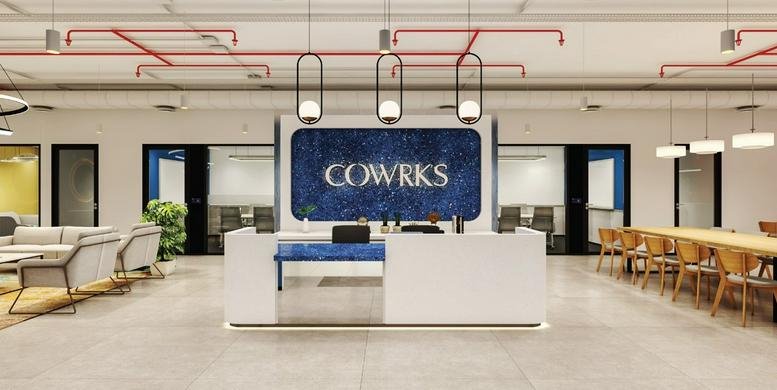 Reception area at 1st Floor, Campus 3B, Outer Ring Rd, Adarsh Palm Retreat with blue branded backdrop.