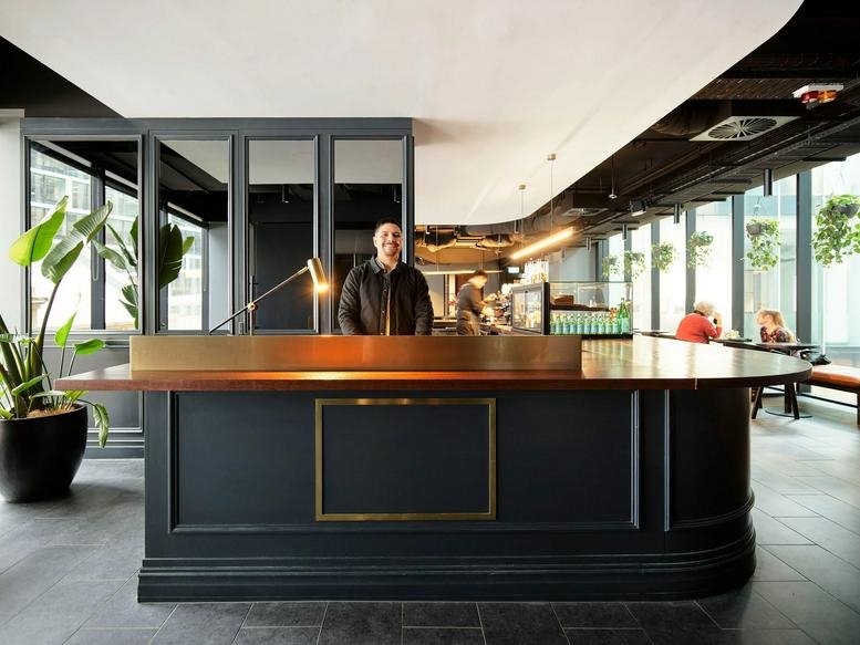 Modern dark grey reception desk at Customs House, 31 Alfred Street, Circular Quay, Sydney with wooden accents.
