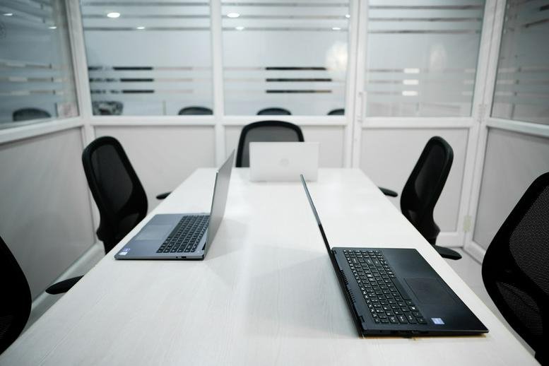 Meeting room with white tables and glass partitions at Sri Krishna Arcade.