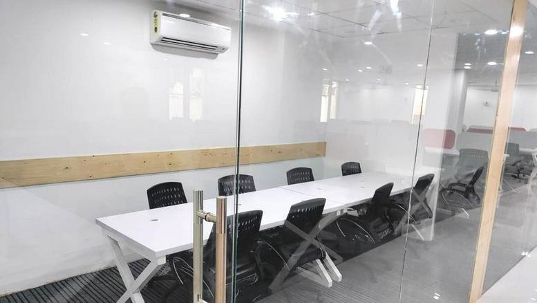 Bright glass-walled meeting room at E-5, F/F, Left Side, (Old No. -133), Western Marg, Lane No-1, Saidulajab.