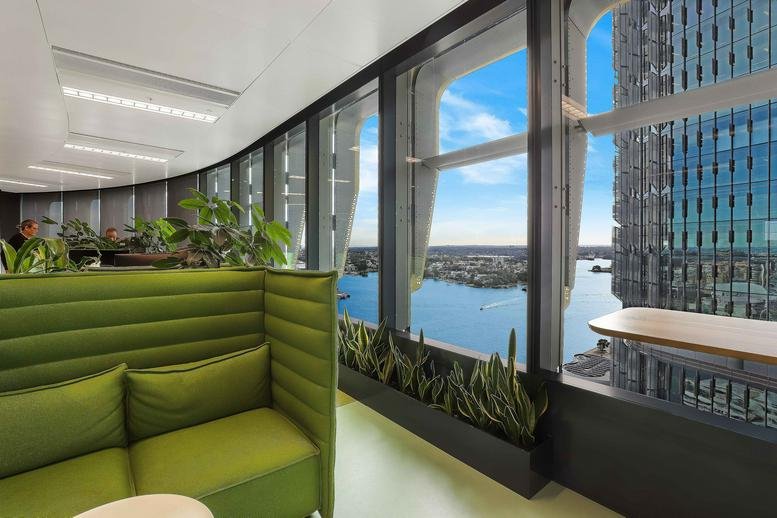 Breakout area at International Tower Three with green banquette seating and expansive harbor views.