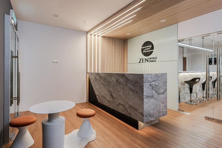Modern reception desk with a marble-effect facade under warm wooden slat lighting.