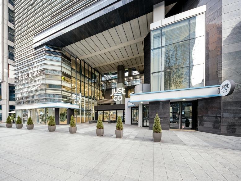 Exterior view of the contemporary glass facade of JustCo Tower, Seoul.