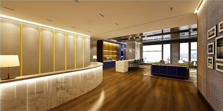 Spacious lobby at K11 Atelier featuring a curved marble desk and warm wood flooring.