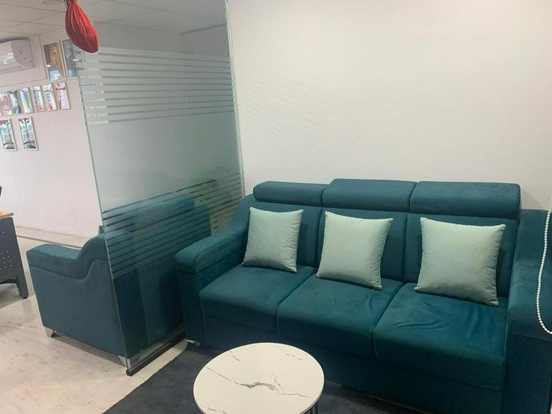Plush teal sofa and lounge area at Kailashnath Arcade, Suite 401, 100 ft Road, Madhapur, Hyderabad.