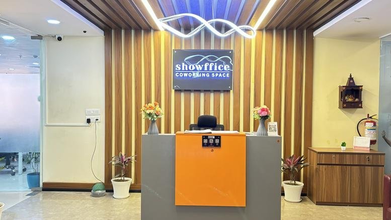 Modern reception area at 8th Floor, Lucknow, India with wood-slat walls and orange accents.