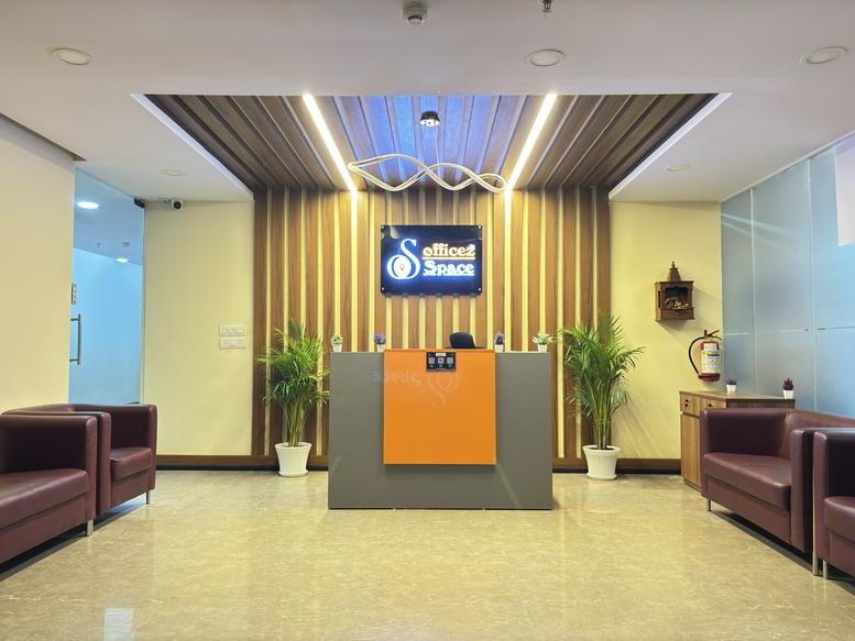 Welcoming entrance area of 8th Floor, Lucknow, India with wood-paneled walls and plush purple seating.