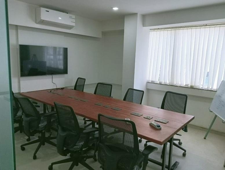 Meeting room at Near Sygenta Company, Baner Balewadi Road, 4th Floor with long wooden table and wall-mounted TV.