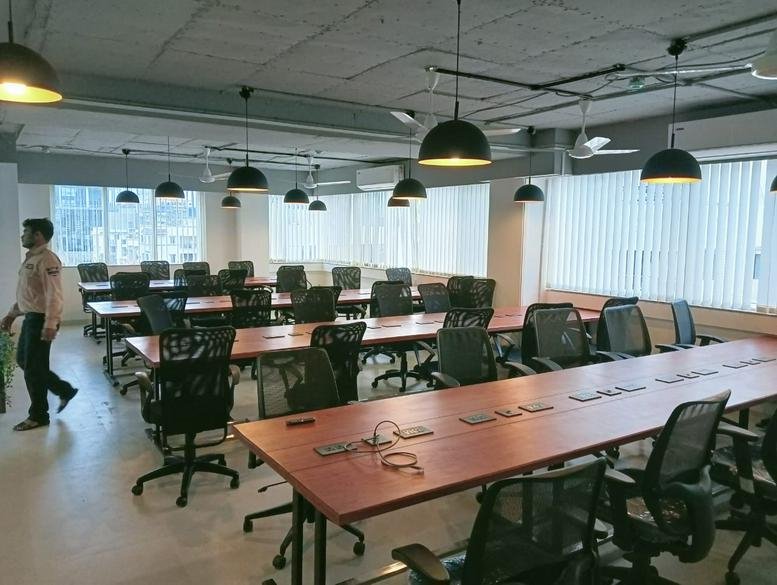 Large open-plan workspace at Near Sygenta Company, Baner Balewadi Road, 4th Floor, Pune with rows of desks.