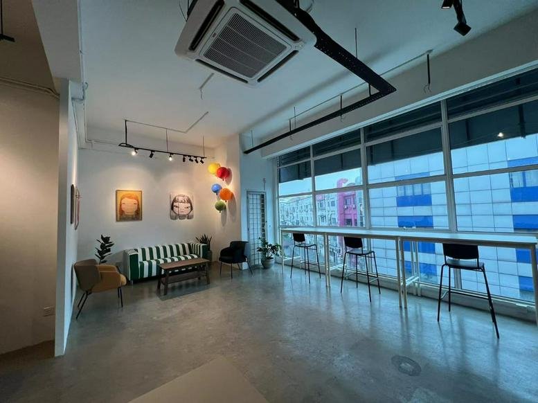 Spacious communal lounge at Number 8, 2, Jalan Radin Bagus 8, Kuala Lumpur featuring a striped sofa and window bar.