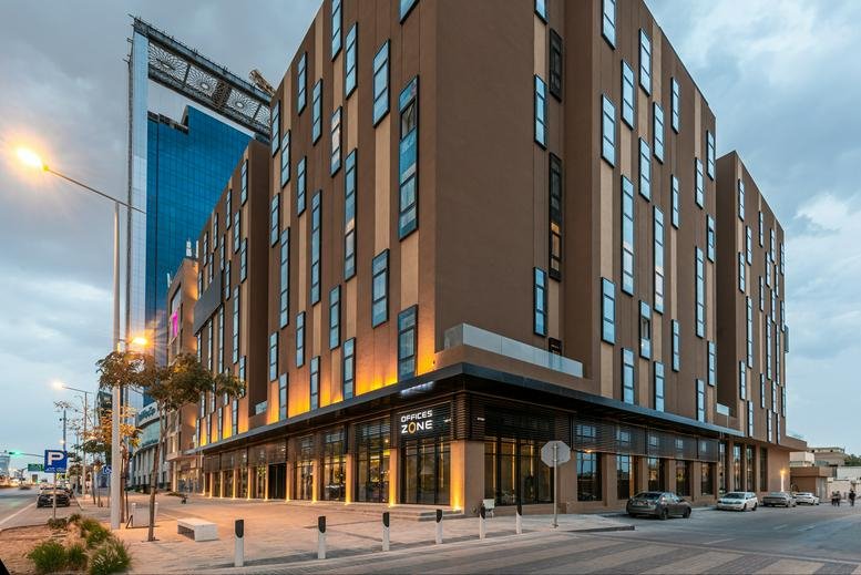 Exterior view of the contemporary brown and glass building on Olaya Street, Olaya District.